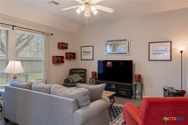 living room featuring lofted ceiling, a healthy amount of sunlight, and ceiling fan