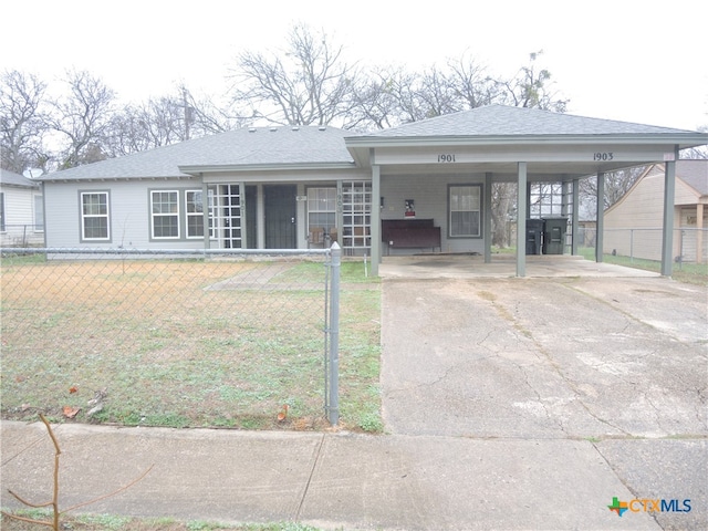 ranch-style house featuring a front lawn and a carport