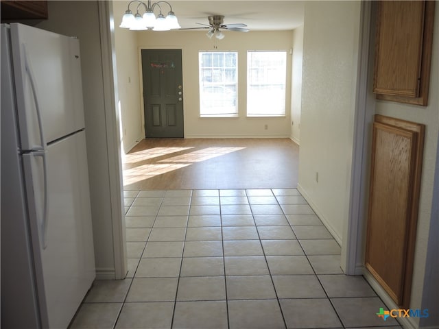 kitchen with ceiling fan, light tile patterned flooring, and white refrigerator