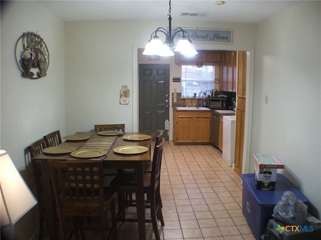 tiled dining space featuring sink and a chandelier