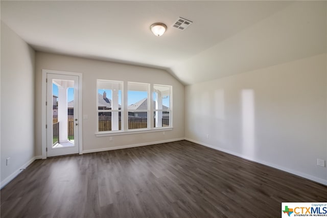 bonus room featuring dark wood-type flooring and vaulted ceiling