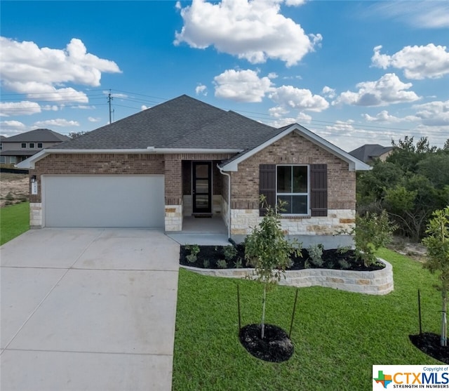 single story home featuring a garage and a front lawn