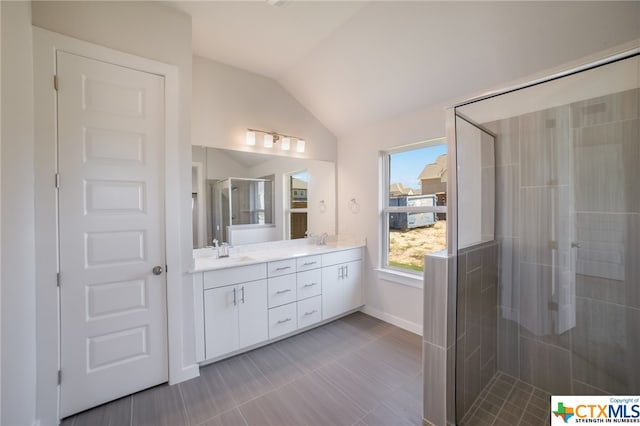 bathroom with vanity, an enclosed shower, and lofted ceiling