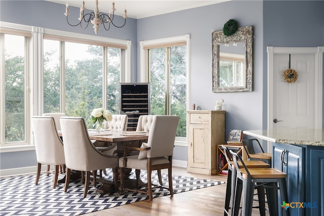 dining space with light wood-type flooring and a chandelier