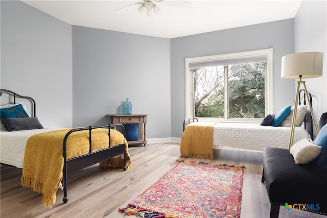 bedroom with light hardwood / wood-style flooring and ceiling fan