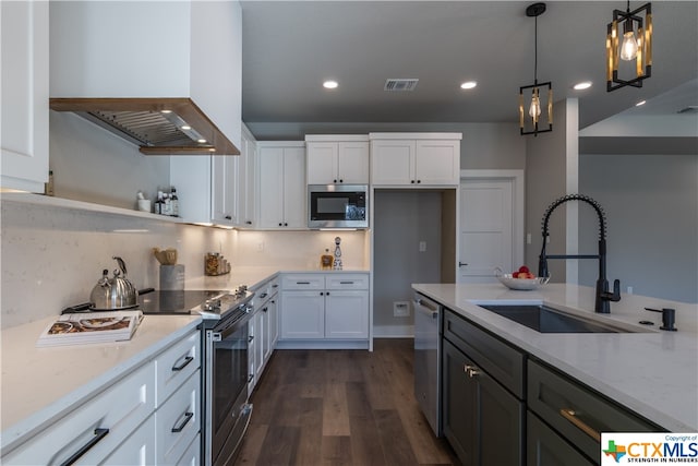 kitchen featuring white cabinets, appliances with stainless steel finishes, light stone countertops, and sink