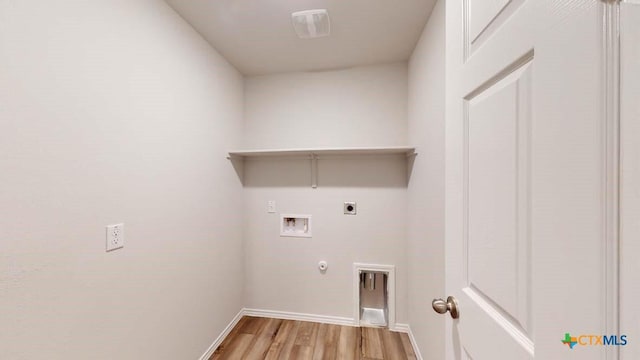 washroom featuring electric dryer hookup, hookup for a gas dryer, hookup for a washing machine, and light wood-type flooring