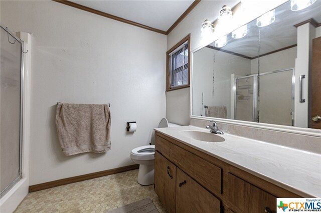 bathroom with vanity, ornamental molding, toilet, and walk in shower