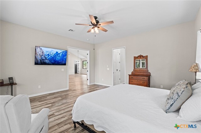 bedroom with ceiling fan and wood-type flooring