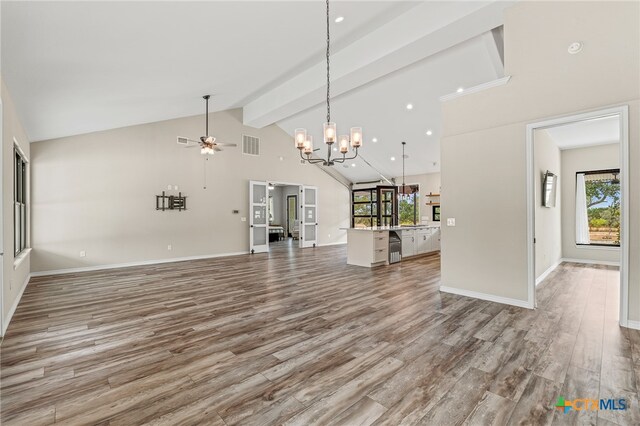 unfurnished living room with hardwood / wood-style floors, ceiling fan, beam ceiling, and high vaulted ceiling