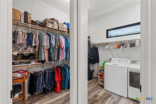 laundry room featuring washing machine and clothes dryer and wood-type flooring