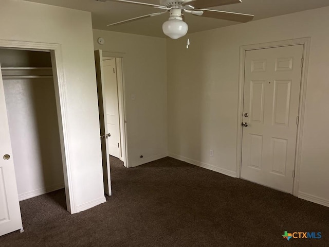 unfurnished bedroom featuring ceiling fan, baseboards, a closet, and dark carpet