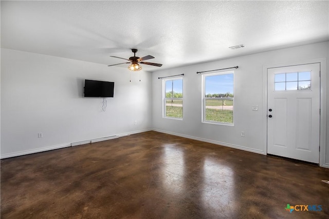 foyer entrance featuring ceiling fan and a textured ceiling