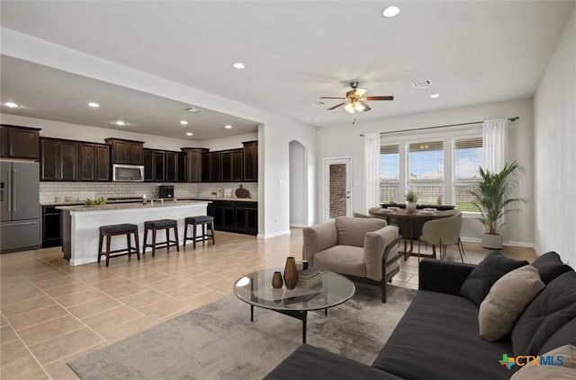 30125 Prairie Creek Ct, Brookshire, TX 77423 - living room with arched walkways, recessed lighting, a ceiling fan, and light tile patterned floors