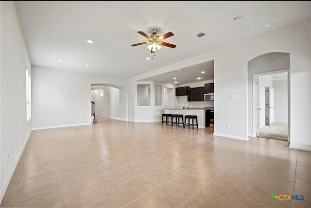 30125 Prairie Creek Ct, Brookshire, TX 77423 - living room featuring arched walkways, a ceiling fan, and recessed lighting
