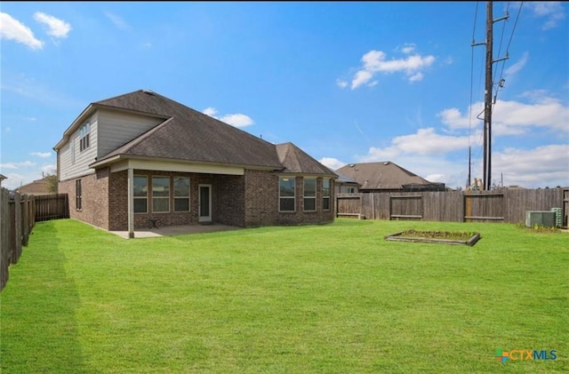 30125 Prairie Creek Ct, Brookshire, TX 77423 - back of house with brick siding, a fenced backyard, and a patio area