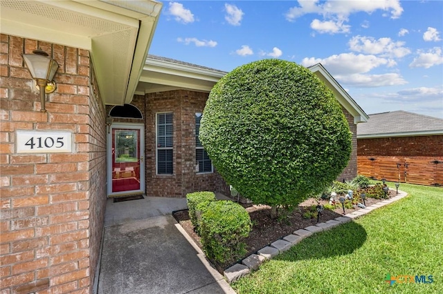 4105 Whispering Oaks, Temple, TX 76504 - property entrance featuring brick siding and a yard