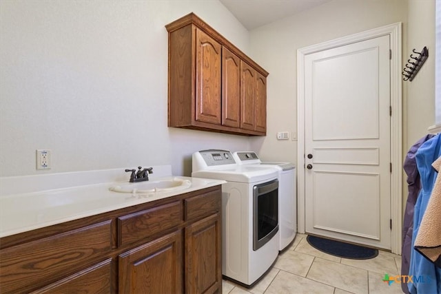 laundry area featuring cabinets, separate washer and dryer, sink, and light tile patterned floors