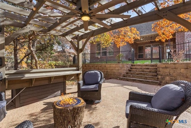 view of patio featuring an outdoor fire pit, fence, and a pergola