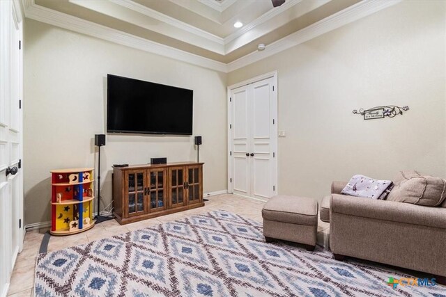 bedroom featuring a raised ceiling, ceiling fan, light carpet, and ornamental molding