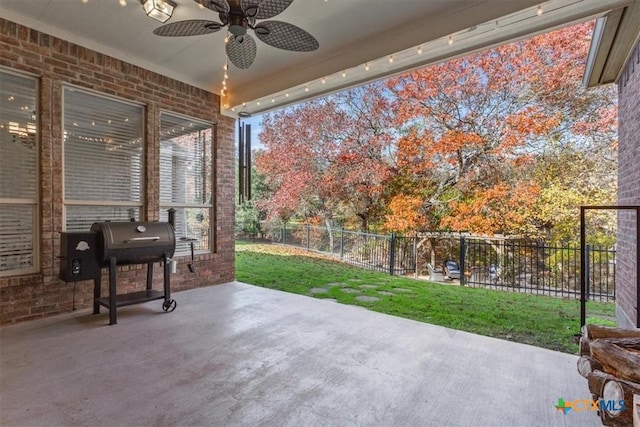 view of patio / terrace with ceiling fan, area for grilling, and fence