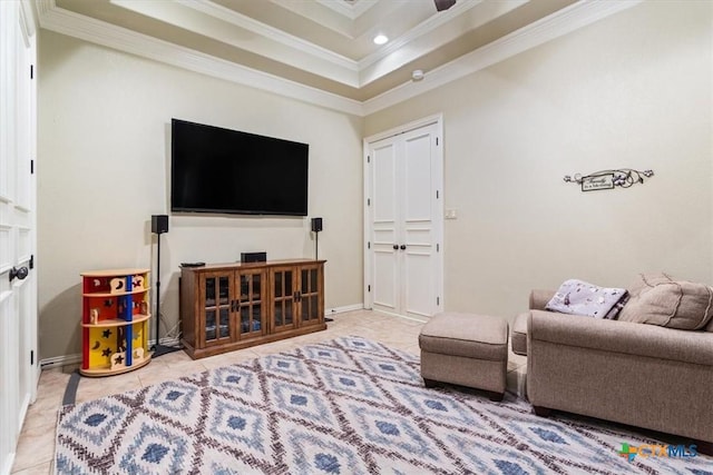 tiled living room featuring a tray ceiling and ornamental molding