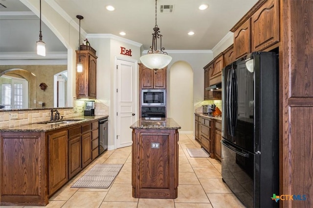 kitchen featuring backsplash, pendant lighting, sink, and stainless steel appliances