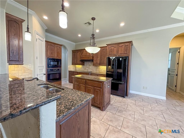 kitchen with arched walkways, crown molding, visible vents, dark stone counters, and black appliances