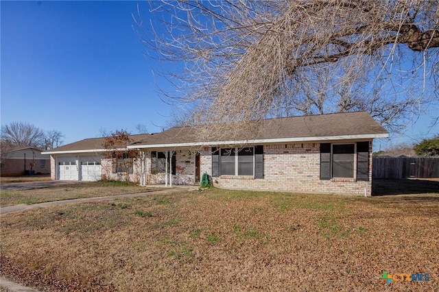 ranch-style house with a garage and a front lawn