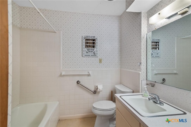 full bathroom with washtub / shower combination, vanity, toilet, and tile walls