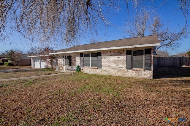 ranch-style home with a garage and a front lawn