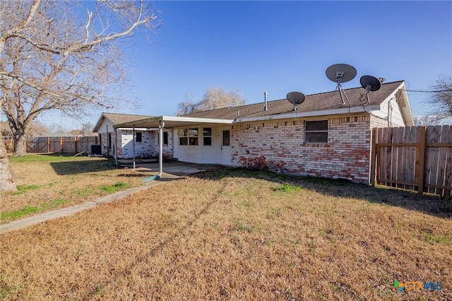 back of property with a patio and a yard