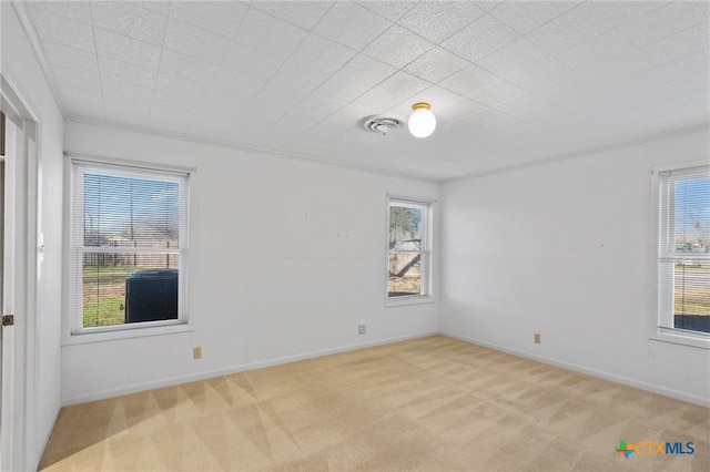 carpeted empty room featuring ornamental molding