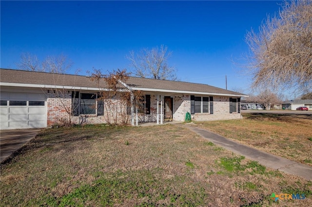 ranch-style house featuring a garage and a front lawn