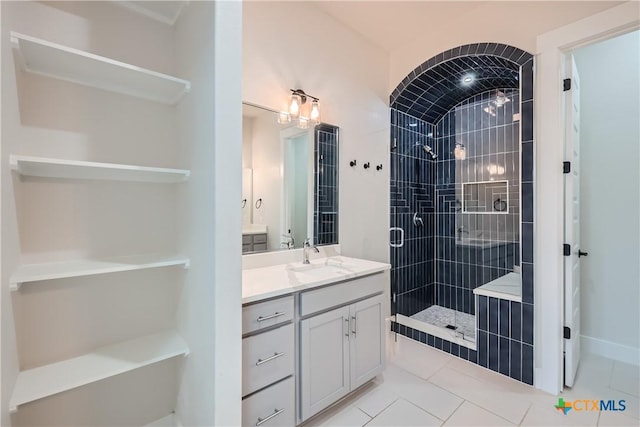 bathroom featuring vanity, tile patterned floors, and walk in shower