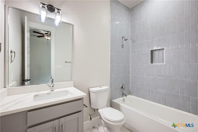 full bathroom featuring toilet, tiled shower / bath combo, ceiling fan, and vanity