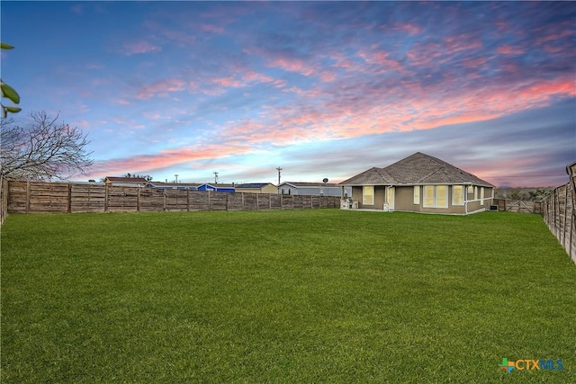 view of yard at dusk