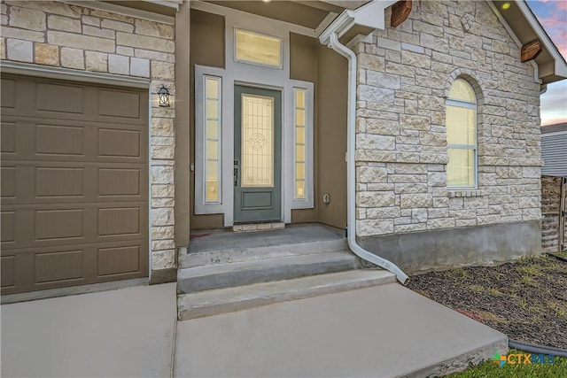 exterior entry at dusk with a garage