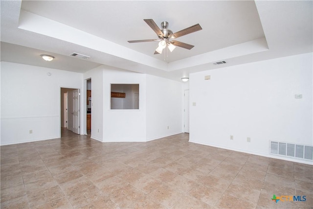 5111 Warwicke Dr, Temple, TX 76502 - empty room featuring a raised ceiling, a ceiling fan, and baseboards