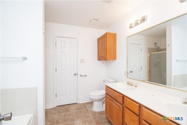 5111 Warwicke Dr, Temple, TX 76502 - full bathroom featuring a stall shower, double vanity, a bath, and toilet