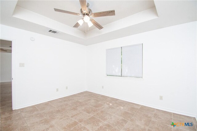 5111 Warwicke Dr, Temple, TX 76502 - empty room with a raised ceiling, a ceiling fan, and baseboards
