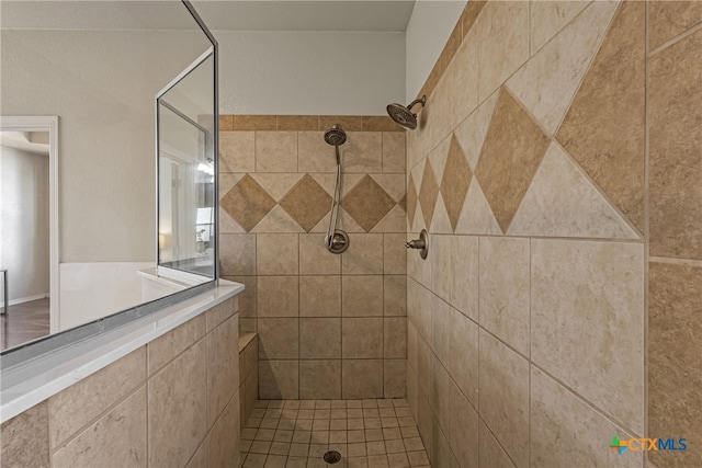 bathroom featuring tile patterned flooring and a tile shower