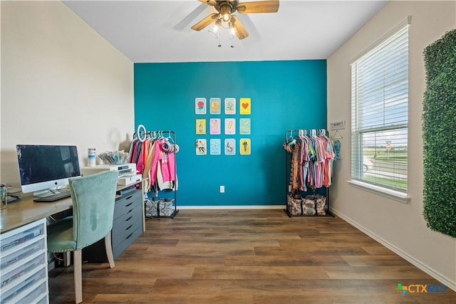 home office with dark wood-type flooring and ceiling fan