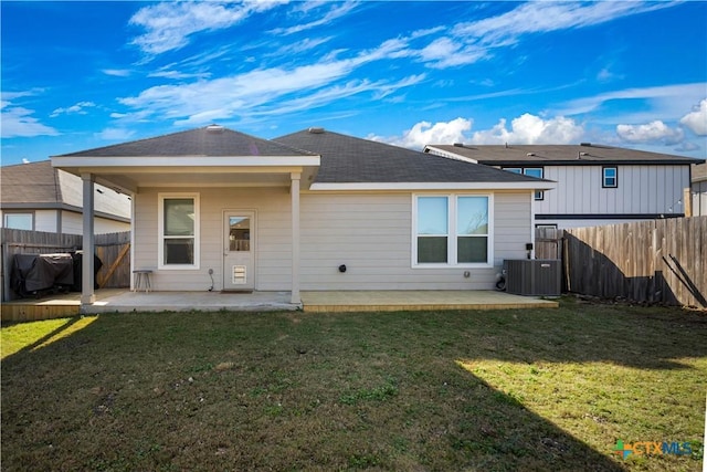 back of property featuring cooling unit, a lawn, and a patio area