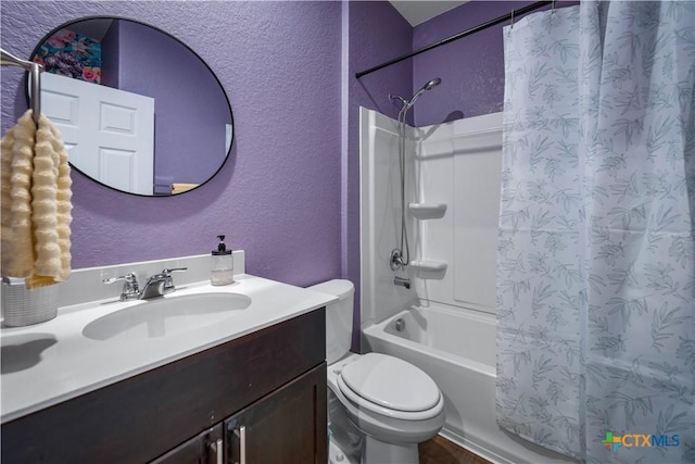 full bathroom with vanity, shower / tub combo, and toilet