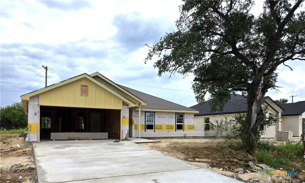 1417 Fossil Trl, Belton, TX 76513 - property in mid-construction featuring a garage, concrete driveway, and board and batten siding