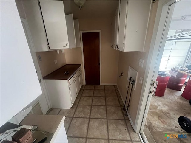 kitchen with white cabinets and baseboards