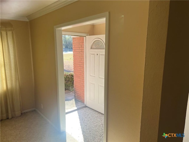 interior space featuring crown molding and baseboards