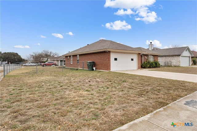 view of side of property with a garage and a yard