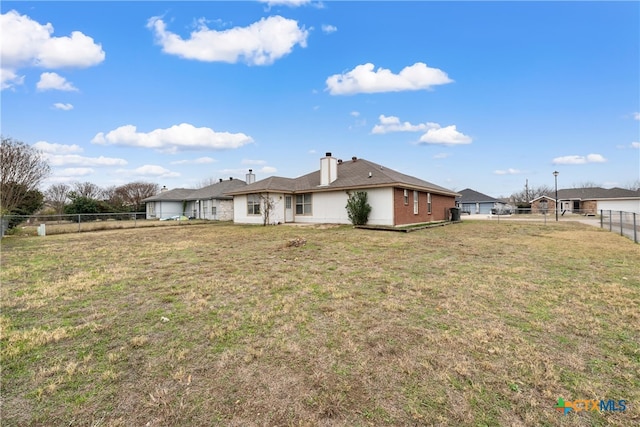 rear view of house with a yard